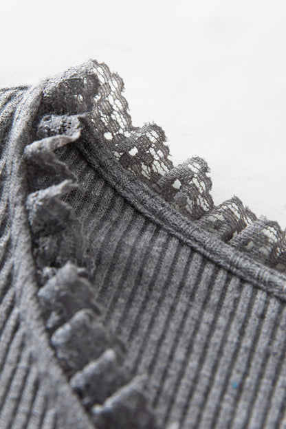Close-up of ruffle trim on gray ribbed dress