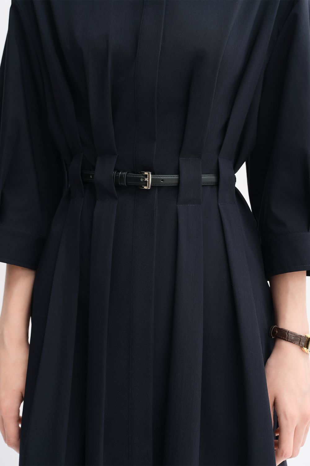 Close-up of waistline belt detail on black dress