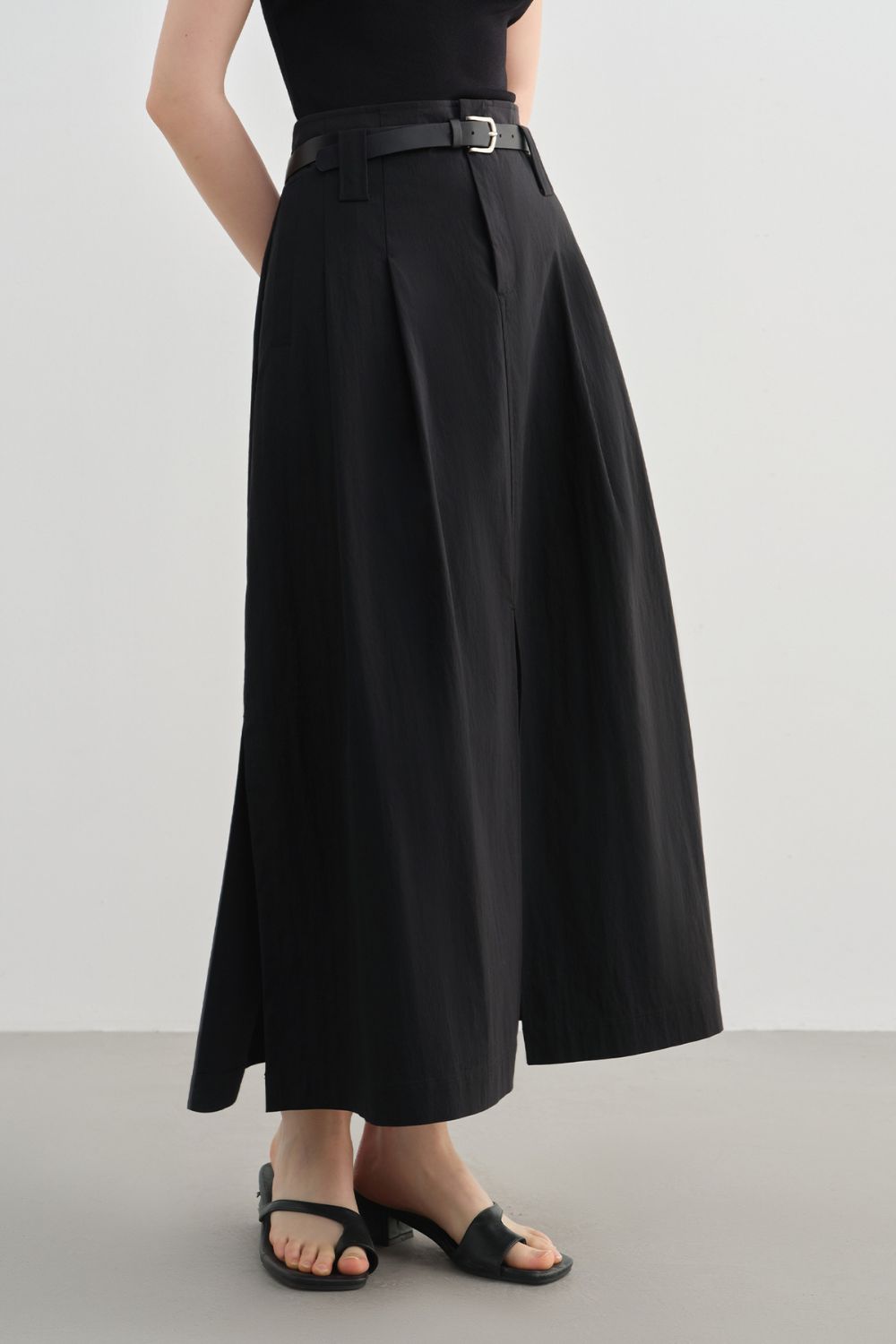 Side view of black midi skirt showing pocket detail