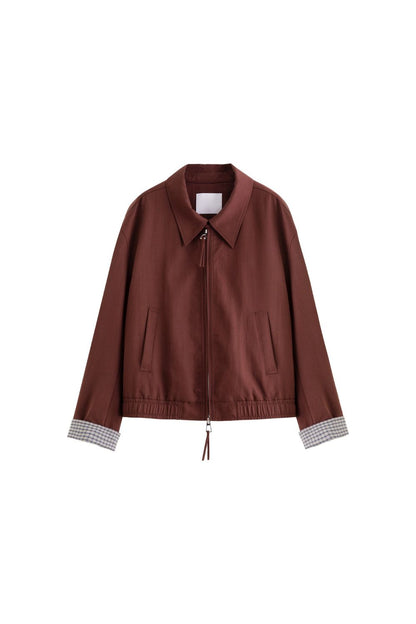 Flat lay of brown jacket with check inner lining