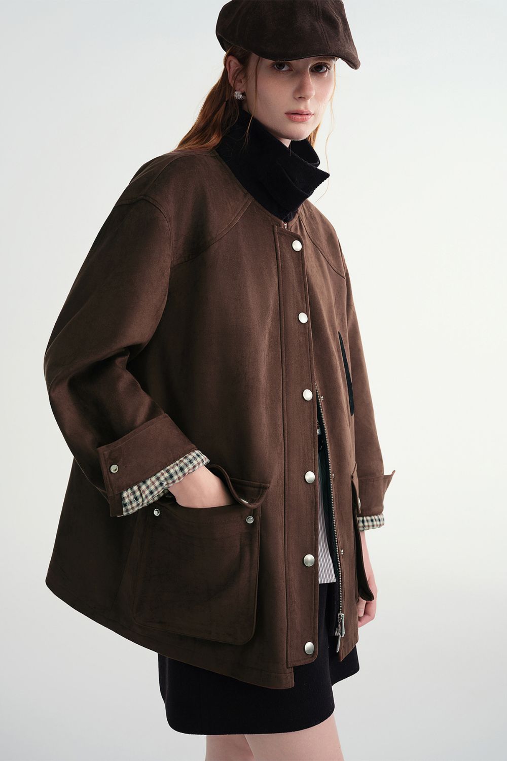 Side view of model in brown button-up jacket with large pockets