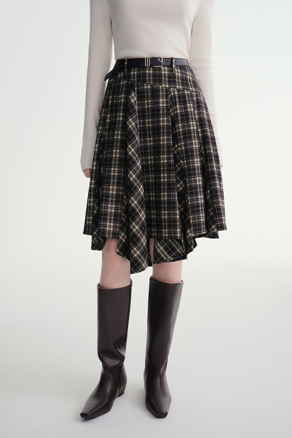 Front view of plaid flared skirt paired with a tucked-in sweater