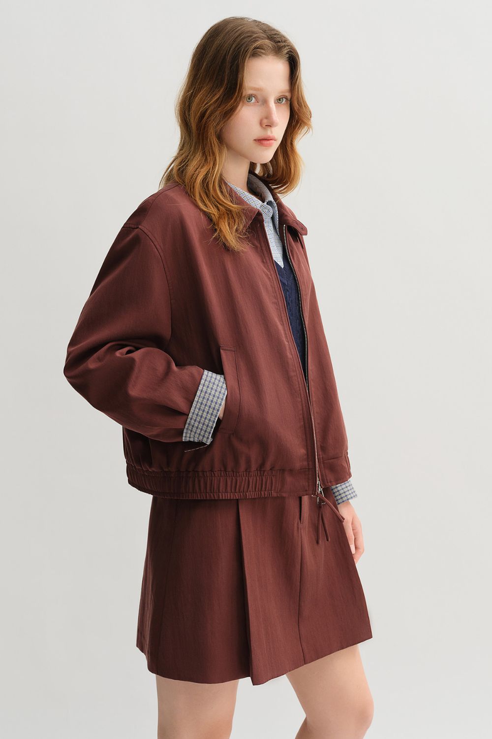 Side view of brown jacket and skirt set with collared shirt