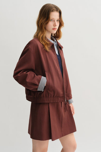 Side view of brown jacket and skirt set with collared shirt