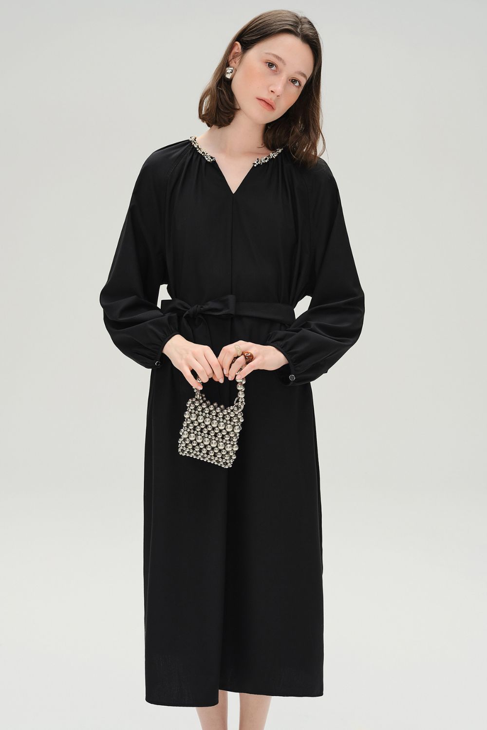 Front view of black midi dress with V-neckline and relaxed fit