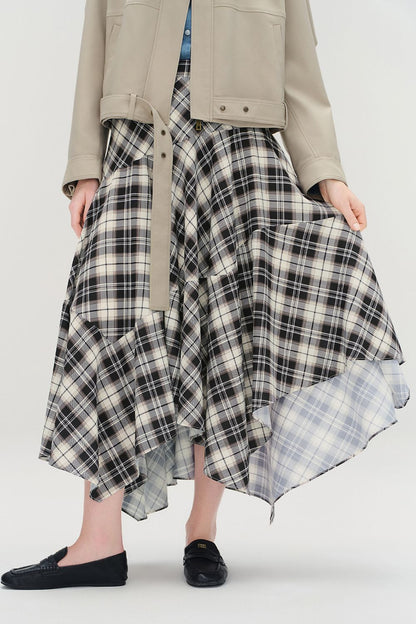 Front view of plaid high-low skirt styled with a beige jacket