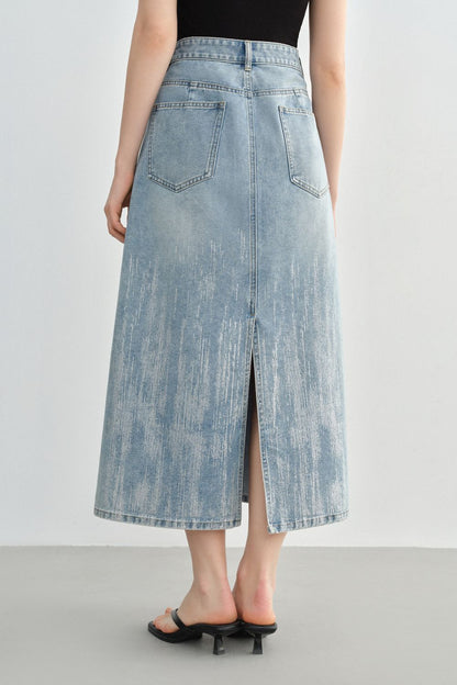 Angled back view of denim skirt highlighting back slit detail