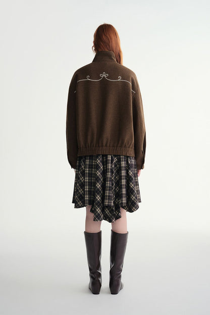 Back view of brown toggle jacket paired with plaid skirt