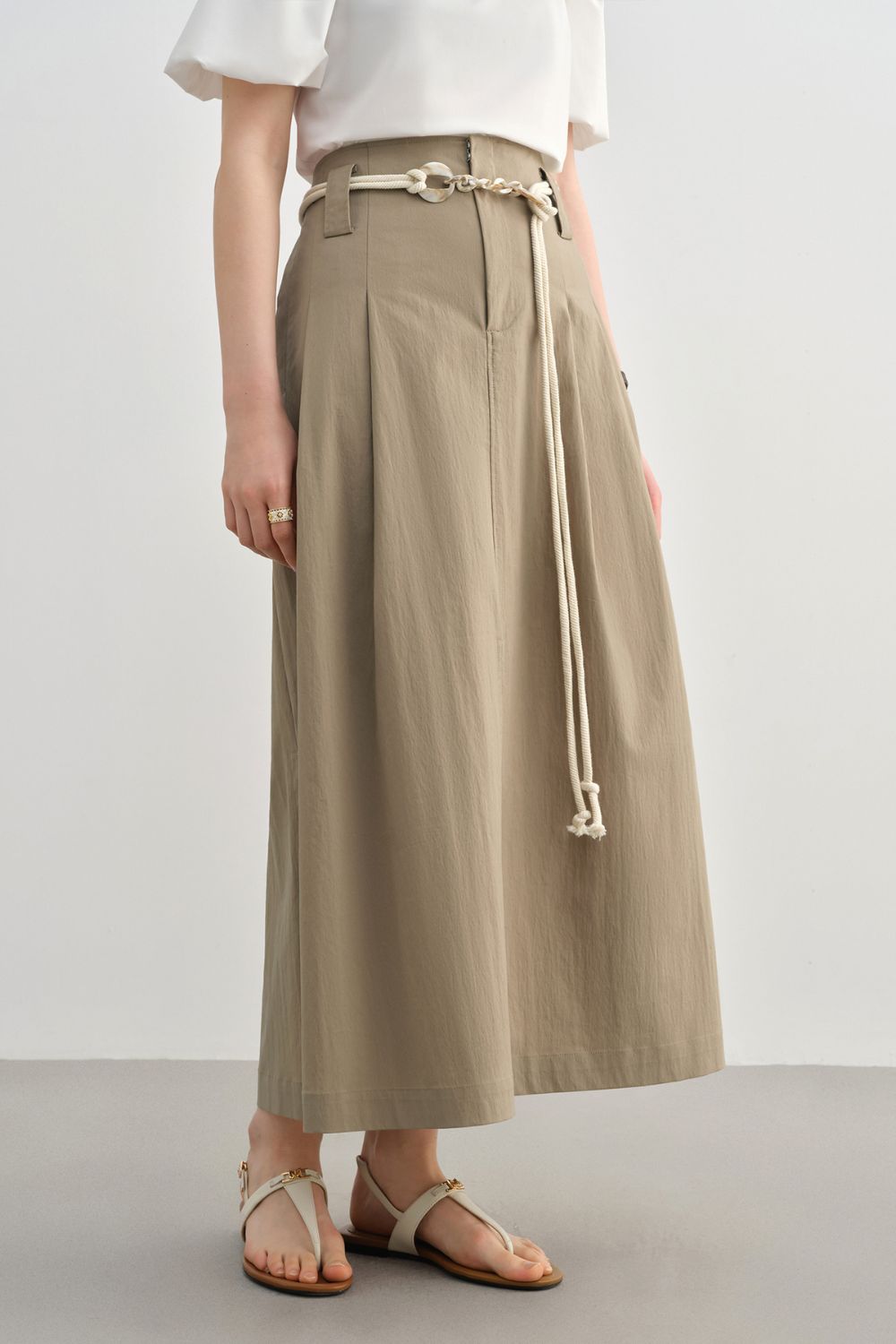 Side view of beige skirt showing waistband and tie detail