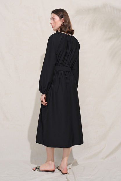 Side view of black long-sleeve midi dress