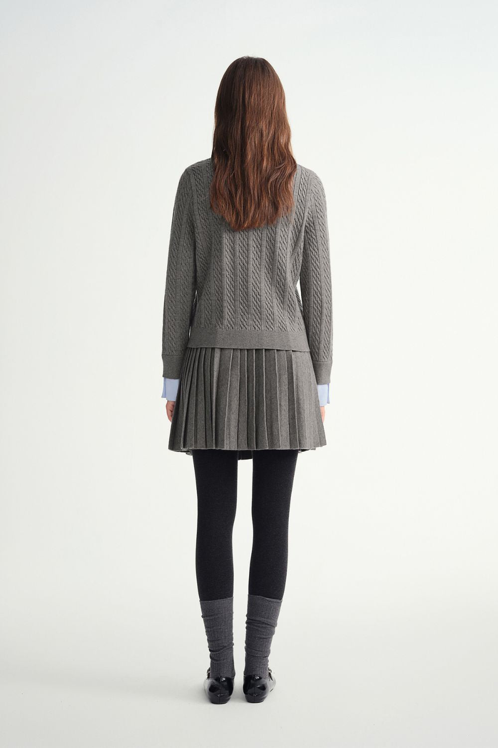 Back view of gray sweater and pleated skirt outfit