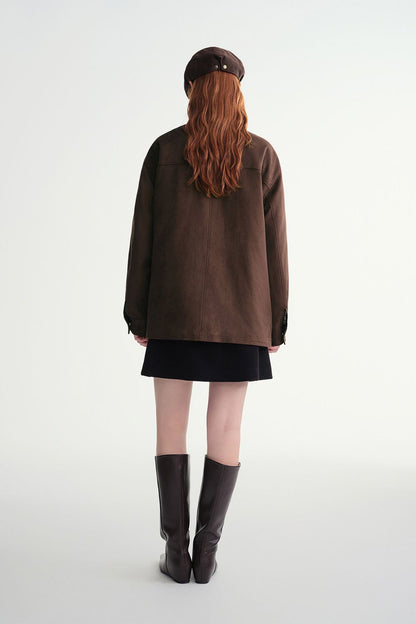 Back view of brown button-up jacket styled with a mini skirt and tall boots