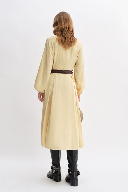 Back view of yellow long-sleeve belted dress