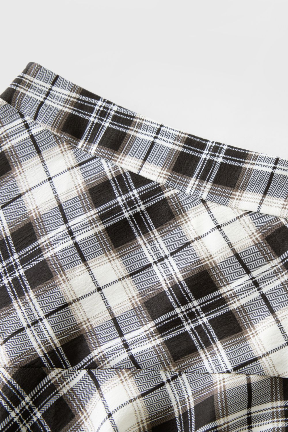 Close-up of plaid fabric pattern in neutral tones