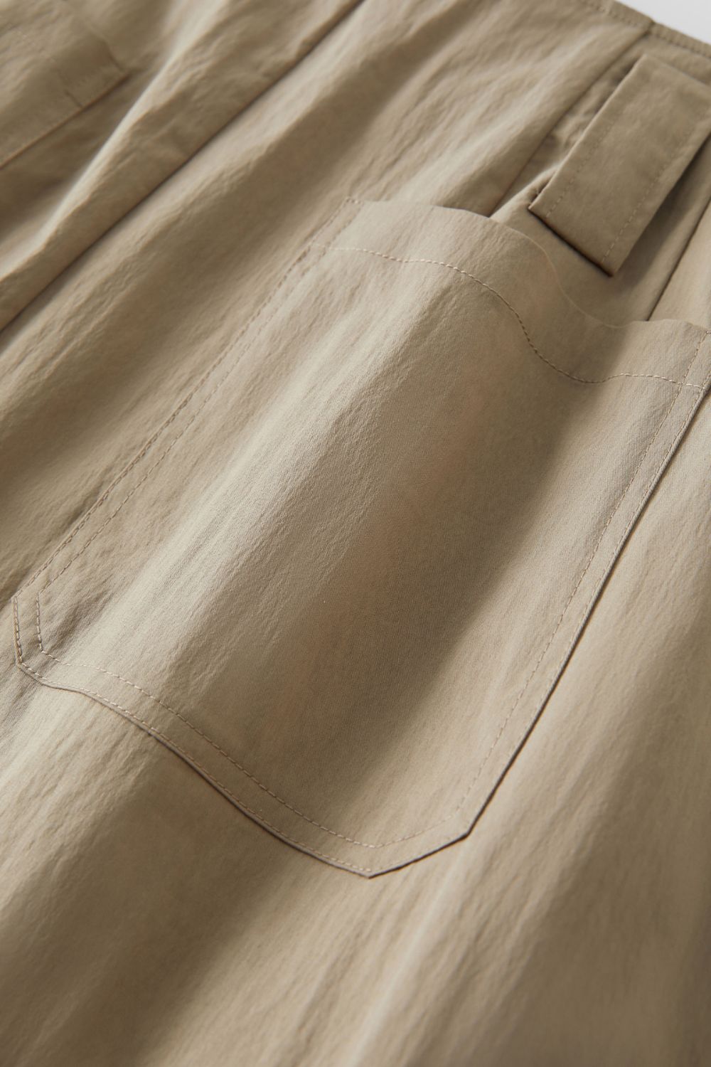 Detailed view of beige skirt pocket stitching