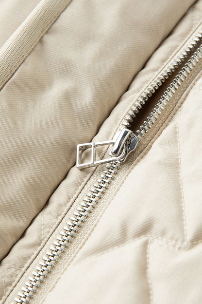 Close-up detail of beige jacket zipper 