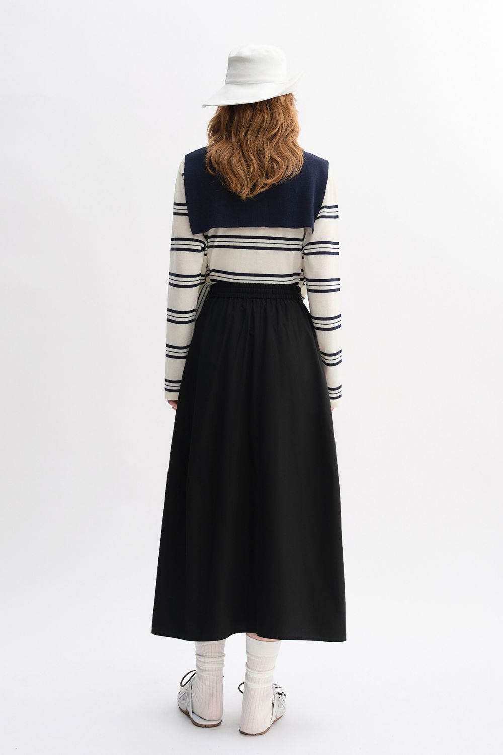 Back view of outfit with striped top and long black skirt