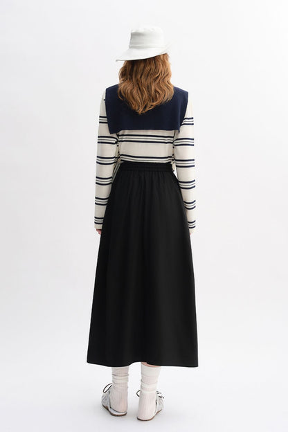 Back view of outfit with striped top and long black skirt
