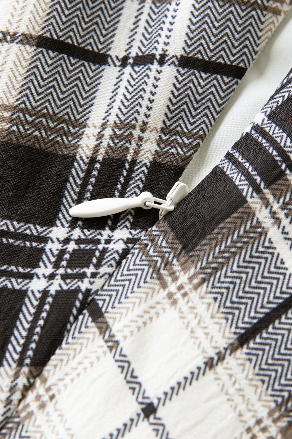 Detailed view of plaid fabric texture and stitching