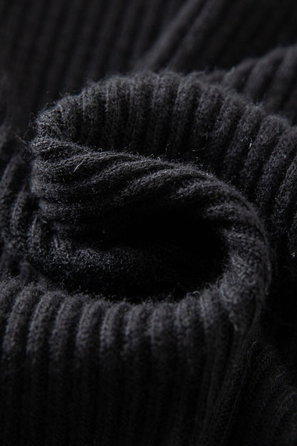 Fabric texture close-up of black ribbed knit material
