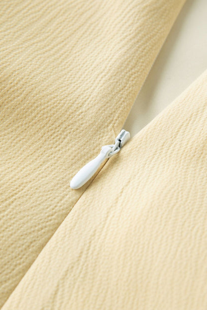 Close-up of button detail on yellow dress fabric