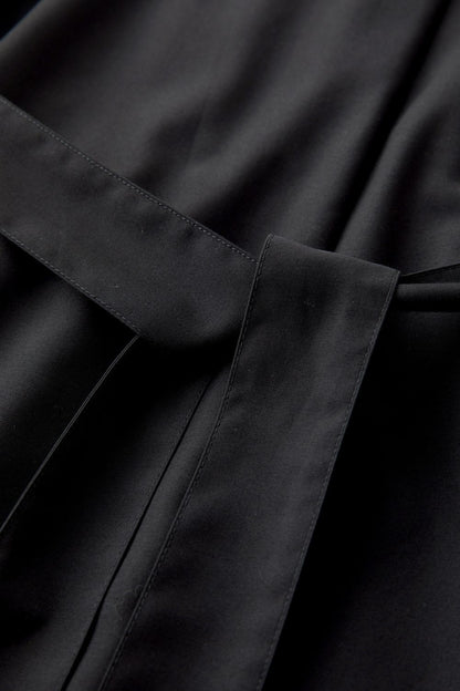 Close-up of fabric texture and stitching on black dress