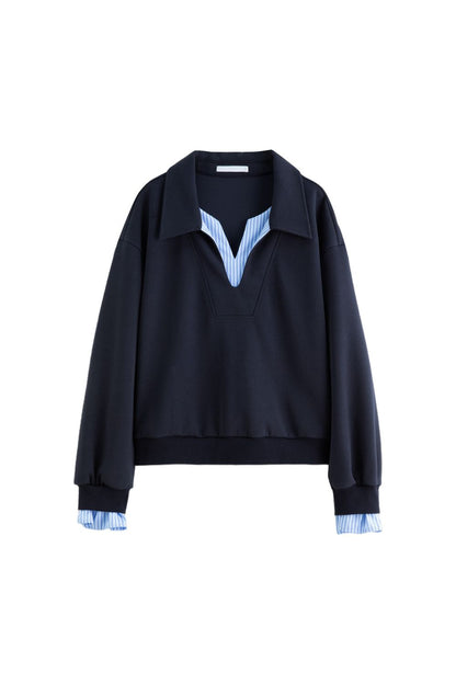 Flat lay of navy blue pullover with light blue striped collar and cuffs