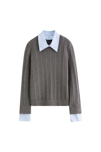 Flat lay of gray cable-knit sweater layered with blue collared shirt
