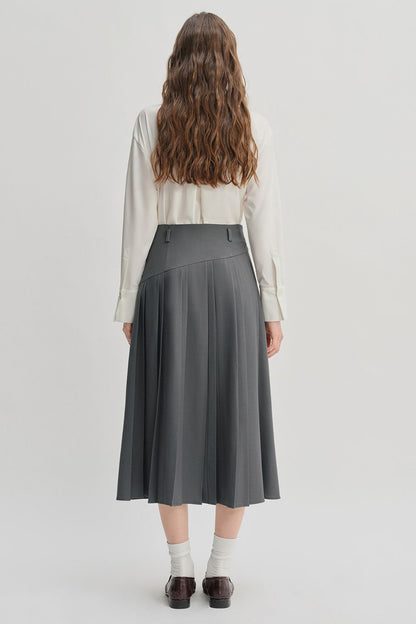 Back view of gray pleated midi skirt styled with light top